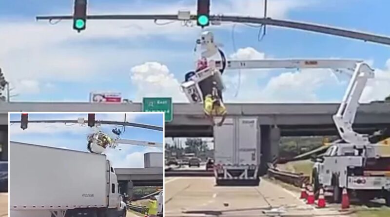 Wild video shows utility worker dangle over busy street after 18-wheeler smashes into him